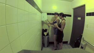 2 bitches are in the public bathroom, licking one another